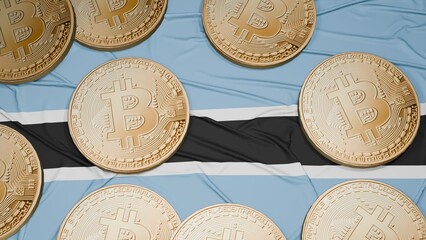 Several bitcoins are laid out on the flag of Botswana