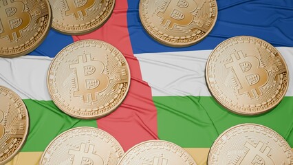 Several bitcoins are laid out on the flag of Central African Republic