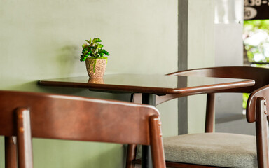 Workspace concept. Chairs and tables for relaxing and working, with small potted plants. A space for sitting or working in a cafe. An empty room in a restaurant. A quiet working corner in a library.