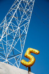 man with a balloon in the shape of number 5