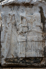 detail of a ancient gladiator armor and sword on a stone carving at patara turkey