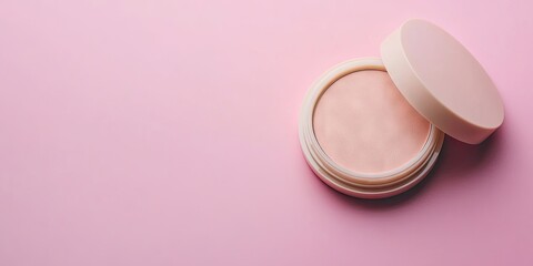 Beige compact case with open lid containing face powder on soft pink background with ample copy space for beauty and makeup advertising