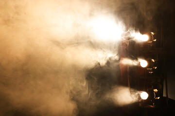 Professional spotlights and smoke on stage in theatre