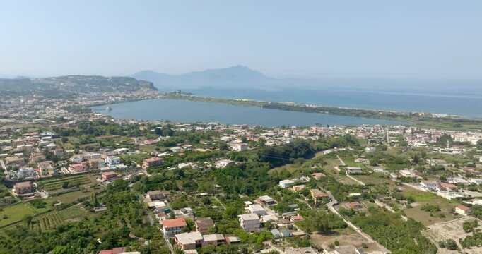 Aerial view of Fusaro Lake located in Bacoli, in the metropolitan city of Naples, Campania, Italy. It is separated from the sea by a narrow coastal strip. It was known by the Latins as Acherusia Palus