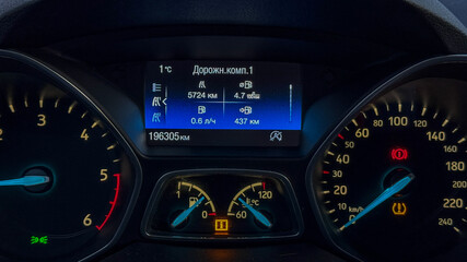 Close-up of a car dashboard displaying the odometer and trip details, highlighting travel and road...