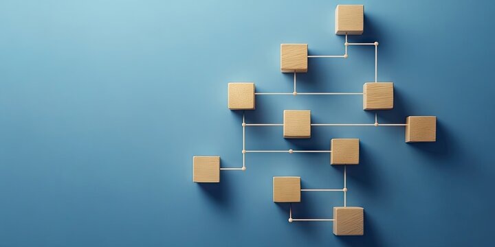 Wooden cube blocks arranged in a flowchart against a blue background symbolizing business process automation with shadows casting toward the bottom left