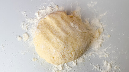 A freshly kneaded dough ball dusted with flour embodies culinary creativity and traditional baking preparations for holidays like Thanksgiving