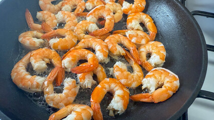 Fresh shrimp sizzling in a pan, capturing the essence of seafood cooking and Mediterranean cuisine