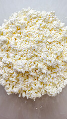 Close-up of fresh white cottage cheese texture, ideal for healthy eating concepts and diet-friendly holiday recipes