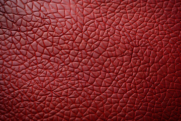 Fototapeta premium Close-up shot of rich red textured leather, showcasing intricate cracked pattern. Ideal for backgrounds, textures, or design projects needing a luxurious feel.