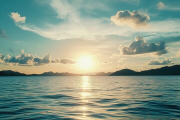 Beautiful Sea Landscape with Blue Sky and Sunset Over Ocean, Mountains in Background, Panoramic View of Calm Water Surface with Sunlight Reflection