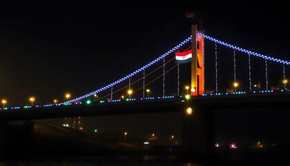 Obraz premium Illuminated Bridge at Night Showing Sudanese Flag