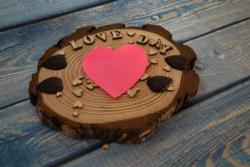 Close-up photo of a valentine's day concept, heart-shaped posit on a wooden board. 
