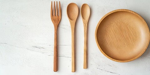 Minimalist wooden kitchenware flat lay featuring a fork two spoons and a round plate on a light marble table with soft natural lighting