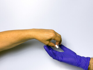 Fototapeta premium A person is giving a pill to another person