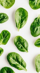Obraz premium Vibrant green lettuce leaves spread evenly on a smooth white surface create an eye-catching visual, perfect for recipe inspiration and showcasing fresh ingredients in cooking