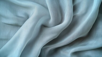 Fototapeta premium Soft, flowing light blue fabric with subtle texture. Draped elegantly, showcasing its luxurious feel and delicate sheen.