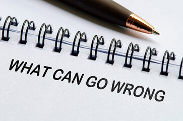 What can go wrong text on white notepad. Business or auditing concept