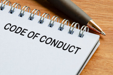 Obraz premium Code of Conduct text on white notepad. Business code of conduct concept