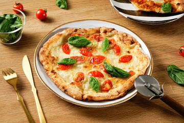 Neapolitan-style pizza. Pizza Margherita thin crust, fresh ingredients, and high edges. Pizza Napoletana