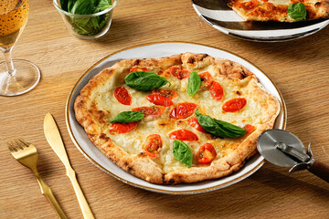 Neapolitan-style pizza. Pizza Margherita thin crust, fresh ingredients, and high edges. Pizza Napoletana