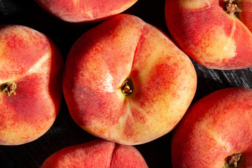 flat peach on black wood background top view