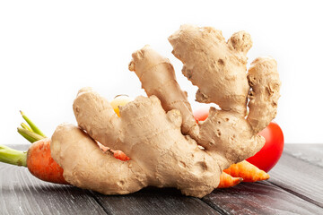 ginger on black wood background on white
