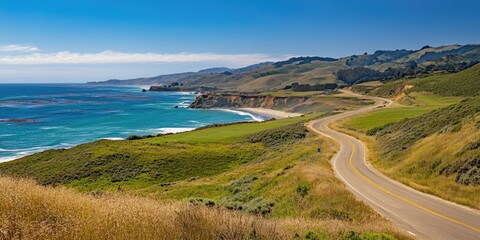 Coastal roadway winding through lush green hills with vibrant blue ocean waves under a clear sky showcasing scenic landscape beauty