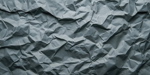 Crumpled grey paper texture with deep creases and subtle shadows in a flat view, showcasing shades of dark and light grey for a vintage feel