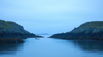 Serene Coastal Landscape with Rocky Shores and Calm Waters Under a Soft Blue Sky at Dawn, Ideal for Nature and Travel Themes in Stock Photography