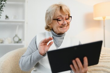 telemedicine concept, old woman with tablet pc during an online consultation with her doctor in her...