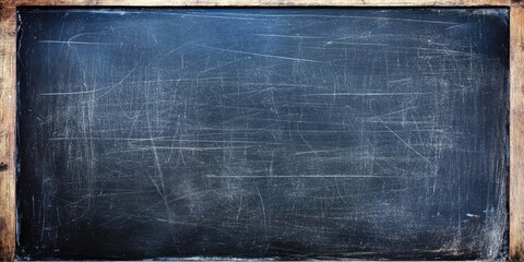 Top view of an empty blackboard with a textured dark surface and rustic wooden frame showcasing faint white chalk marks and scratches.