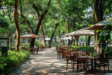 Obraz premium A serene outdoor dining area surrounded by lush greenery and shaded by umbrellas.
