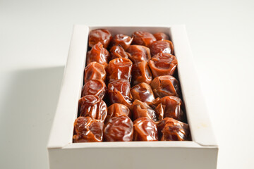 Sukari date in white box packaging, isolated on a white background