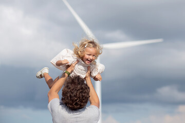 Family with father and daughter playful together with throwing on sky, renewable energy and family...