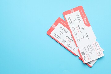Travel agency. Flight tickets on light blue background, top view. Space for text