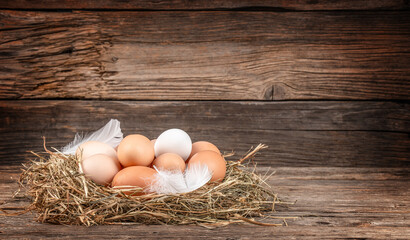 fresh eggs from the farm in the countryside, Chicken eggs in nest of straw on old wooden table...