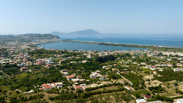 Aerial view of Fusaro Lake located in Bacoli, in the metropolitan city of Naples, Campania, Italy. It is separated from the sea by a narrow coastal strip. It was known by the Latins as Acherusia Palus
