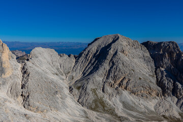 Dolomites rocky summits in the Alps. High tower peaks and sharp mountain rocky peaks of the Alps in the Dolomiti region, Italy. Beautiful scenic mountain range landscape in summer