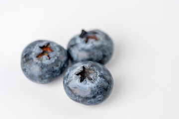 close-up of blueberries on white background