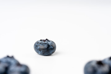 close-up of blueberries on white background