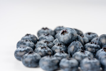 close-up of blueberries on white background