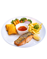 Salmon steak with sweet sour sauce. Served on white plate with grilled corn, carrot, beans, broccoli, fries and slice of tomato and onion. Lemon makes more delicious