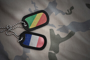 vintage army blank, dog tag with flag of republic of the congo and france on the khaki texture...