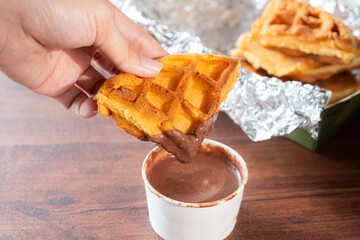 Waffle Dipping in Chocolate Sauce