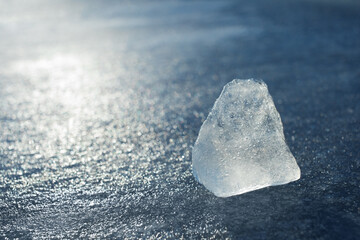 Natural ice crystal cube on frozen river outdoor. Air cooling and refrigerate, global warming,...