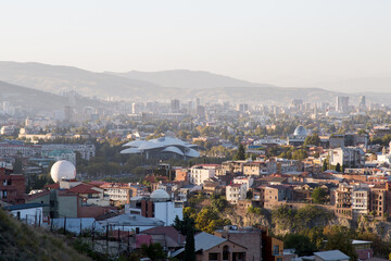Fototapeta premium Panoramic view of central Tbilisi, Georgia, showcasing modern and historic buildings, with a mountainous landscape in the background, concept of urbanization and cultural heritage