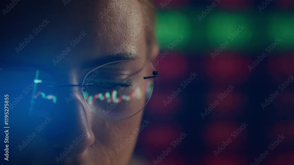 Poster trader wearing glasses is working on laptop computer. screen with stock market charts and bitcoin bt