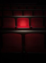 Obraz premium 映画館のスポットライトで浮かぶ赤の座席 