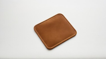 Square suede patch with stitching, ideal for branding projects.